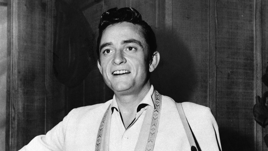 singer johnny cash playing guitar on television special