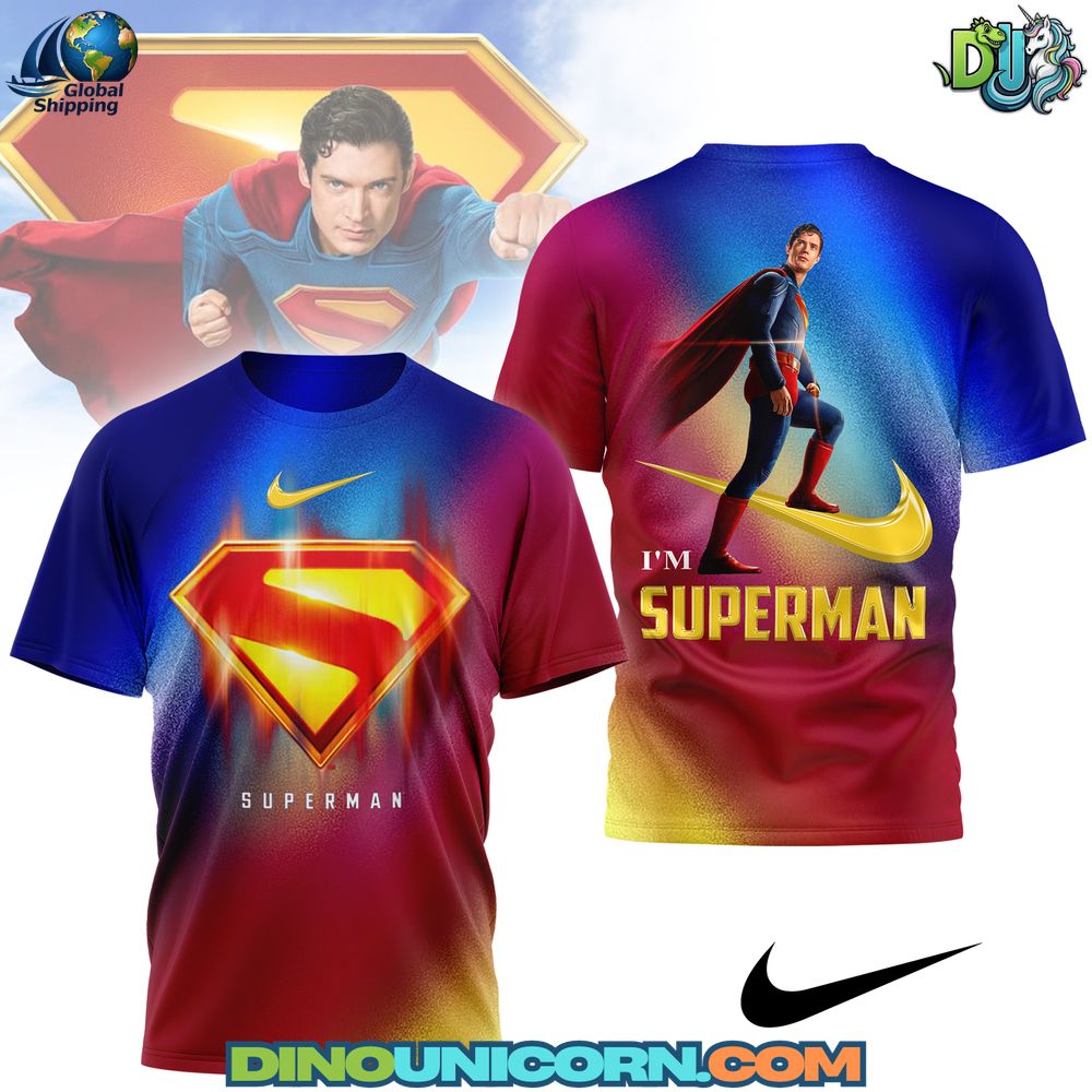 Superman Tshirt Superman T-shirt with bold S-shield emblem, red-blue-yellow gradient background, and dynamic flying hero graphic in vibrant comic-book style.